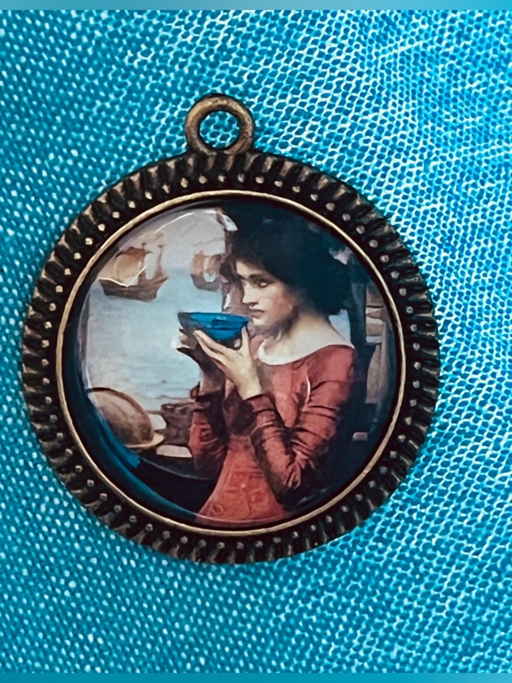 Round pendant featuring a miniature reproduction of the 1900 painting Destiny